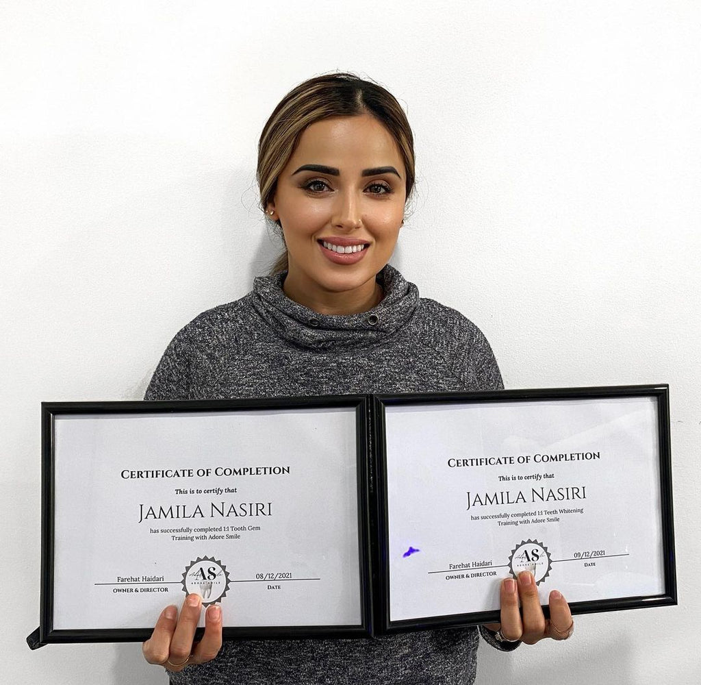 Student stand with her two certificate