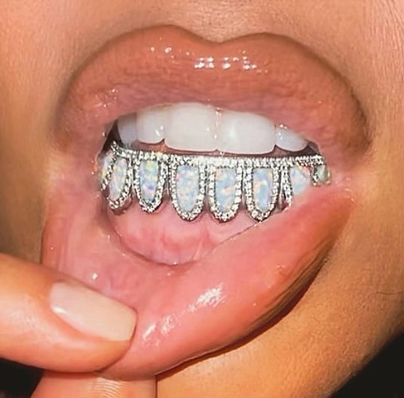 Close-up of a mouth with a diamond grill on the teeth.